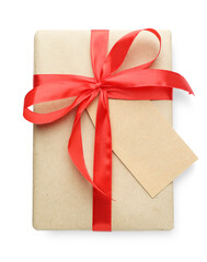 Gift wrapped in kraft paper with bow and card isolated on white, top view