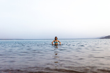 Girl relaxing and swimming in the waters of the Red Sea in Israel. Summer seascape with a girl.