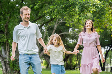 Fototapeta premium Happy family parent children having picnic outdoor activity. Enjoy happiness moment summer playing together including father mother son and daughter relaxing in the morning sunrise.