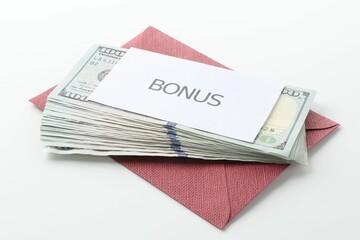 Envelope with word Bonus and dollar banknotes on white background