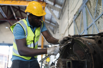 Locomotive repair garage, Mechanic, Engine Mechanic. Black people. African American engineer checking, repairing, maintaining locomotive engine. Railway engineer and train wheel in train garage