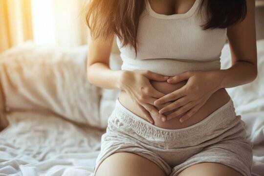 Woman suffering from stomach and menstrual pain at home