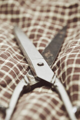 Old scissors on checked  fabric