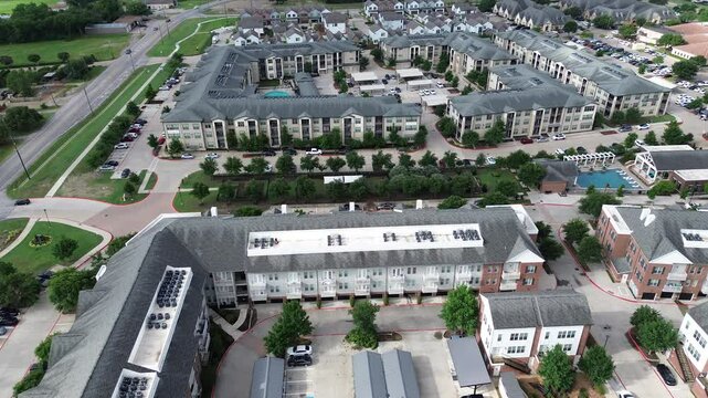 Rooftop HVAC package units on multistory senior living, retirement community apartment homes complex in McKinney Medical District, suburb Dallas, assisted living facilities, covered parking, Texas
