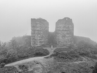 Misty Ruins of an Ancient Fortress. A grayscale image of a misty hilltop with the remnants of a two-towered fortress. Yoros Castle Beykoz Istanbul Turkiye Turkey Anadolu Kavagi 