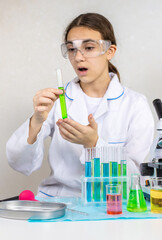 Laboratory research test tubes reagents and microscope. Selective focus.