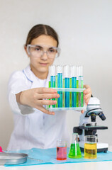 Laboratory research test tubes reagents and microscope. Selective focus.