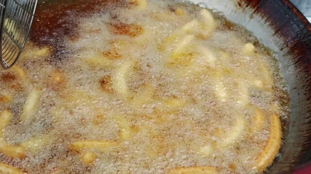Deep-fried Chinese crullers in oil in a pan