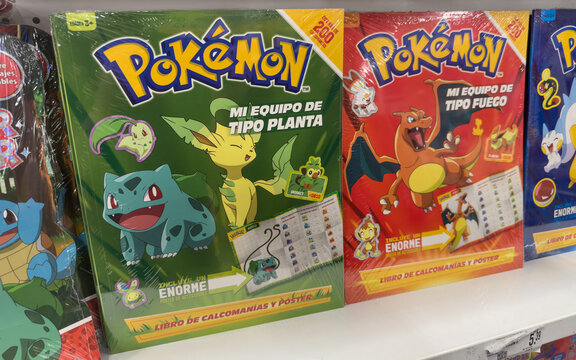Guayaquil, Ecuador, May 29, 2025. Pok&eacute;mon sticker books of grass and fire types on display, perfect for fans and collectors.