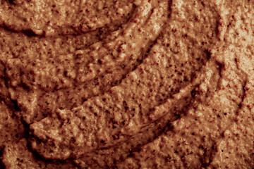 Chocolate ice cream with nuts and banana, texture. Chocolate smoothie cocktail close-up. Nut paste as a background.