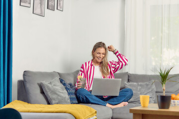 Happy excited successful business woman triumphing in her home office. Work from home/ freelance...