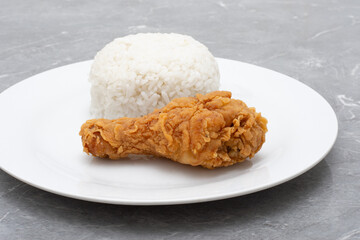 Fast food crispy fried chicken with rice on white plate