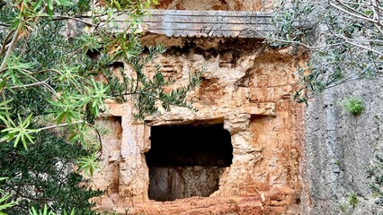 Ruined ancient Lycian tomb in Antalya Province, Turkey. Historical site, archaeological remains, cultural heritage, travel in Turkey, Mediterranean vacation, ancient architecture, lost civilization. 