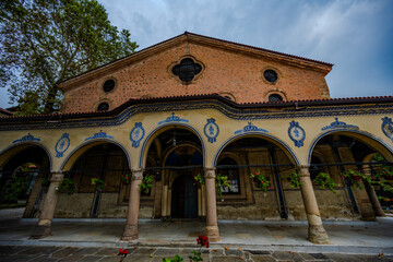 Exterior of the Church of Saint Marina with Ornate Archways and Hanging Flowers in Plovdiv, Bulgaria on a Cloudy Day