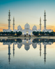 Sheikh Zayed Mosque in Abu Dhabi, UAE, at dusk with reflection in the water
