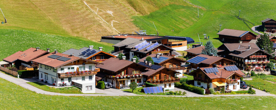 Scenic aerial alpine view austrian mountain village Kals am Grossglockner valley green rural farmland meadow horse pasture background. Austria Alp osttirol National park nature. Summer hiking tourism