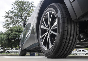 wheel with  tires and aluminium rims. Parked  car vehicle automobile model, in  gray metallic...