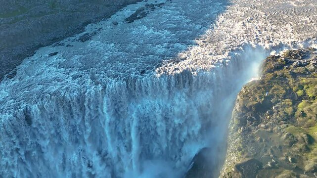 Experience the breathtaking energy of Dettifoss, Europes most powerful waterfall, located in Icelandic wilderness. Water cascades dramatically into the canyon, surrounded by stunning landscapes.