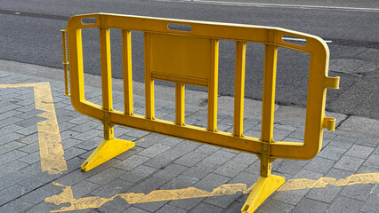 Vibrant yellow barricade amid urban symphony, echoing boundaries of construction dance, perfect for...
