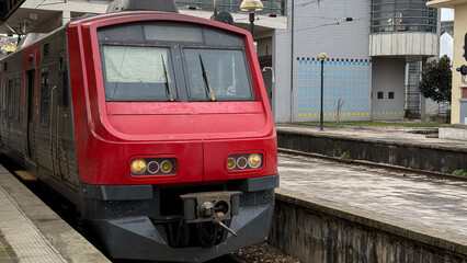 Red commuter train rests quietly at urban station, transit rhythms, Passenger Appreciation Day,...