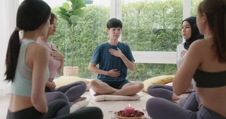 Group of young adult gen z asia people mindful floor sitting circle zen class stress relief self love at studio relax life center. Happy diverse asian LGBT gay deep serene mental health care workshop.