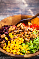 Fresh tomato, cucumber, beans, corn  and chicken salad, mexican style, close-up