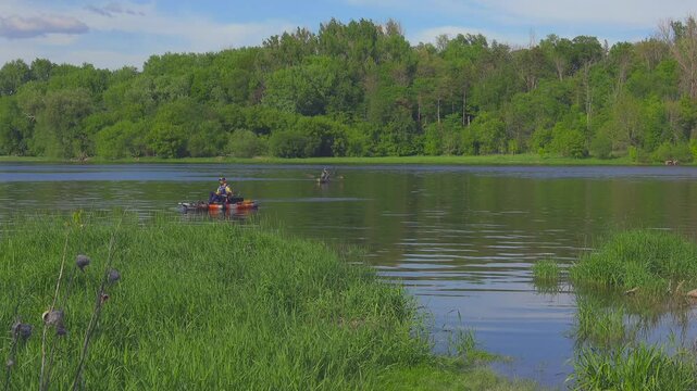 Fishing on a river on canoes