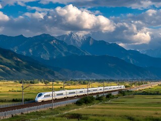 High - speed train traveling through a scenic landscape with mountains