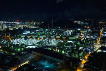 Factory-oil and gas industry, Oil refinery industrial plant at night, oil and gas chemical tank with oil refinery plant background at twilight, business power and energy chemical barrel