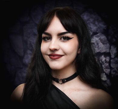 portrait headshot of beautiful pretty goth girl smiling punk rock alternative gothic female model with black hair