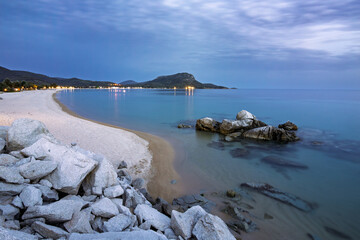 Scenic beach view at dusk with rocks and calm waters near a coastal town Toroni on Sithonia peninsula, Greece