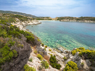 Coastal landscape showcasing clear waters and lush vegetation in a tranquil bay at village Kalamitsi on Sithonia peninsula, Greece