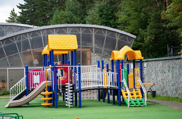 Colorful children's playground in a green park.