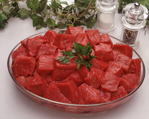 Cut fresh crude meat bowl on kitchen table.