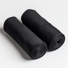 Two black yoga mats on a white background