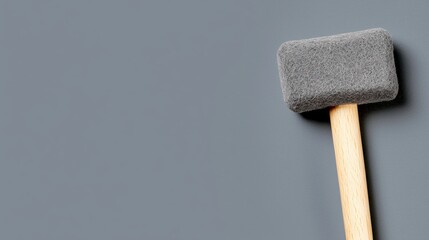 A gray mallet with a wooden handle.