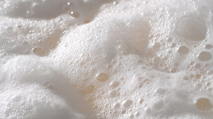 Obraz premium Foaming bath bubbles close up with soft white foam texture and light reflection creating calming and clean feeling