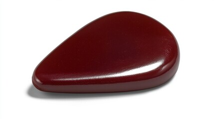 A shiny, dark red, irregularly shaped stone.