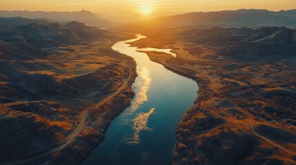 A serene river winding through a rugged mountain valley kissed by the golden glow of sunrise promising a day of