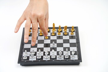 The chessboard. The hand holds the figure. Strategy, business, political games and diplomacy.