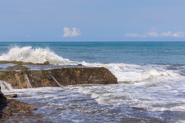 Tanah Lot Temple on the island of Bali known as the island of Gods. Sitting on top of rock island over looking turquoise blue beaches in Bali Indonesia