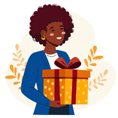 Smiling african american woman holding a festive gift box present. Expressing happiness and generosity concept for holiday celebration.