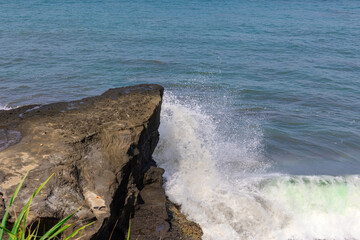 Tanah Lot Temple on the island of Bali known as the island of Gods. Sitting on top of rock island over looking turquoise blue beaches in Bali Indonesia