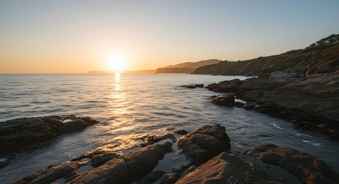 Minimalist rocky coastline with smooth waves at sunset