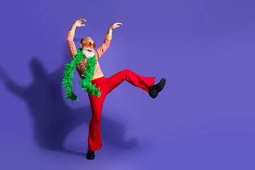 Extravagant elderly man dancing in retro outfit with colorful accessories on vibrant purple background, embodying fun and charisma