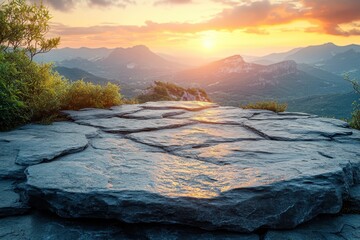 Breathtaking sunset view from rocky outcrop overlooking mountain landscape during golden hour