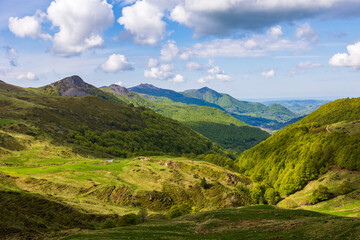 Obraz premium Verdant panorama of the Monts du Cantal from the top of the Jordanne Valley