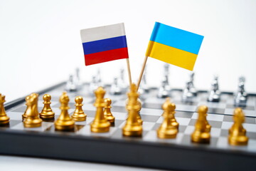 A chessboard with pieces and flags of Russia and Ukraine. Strategy, political game, and diplomacy.