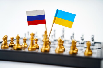 A chessboard with pieces and flags of Russia and Ukraine. Strategy, political game, and diplomacy.