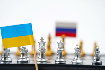 A chessboard with pieces and flags of Russia and Ukraine. Strategy, political game, and diplomacy.
